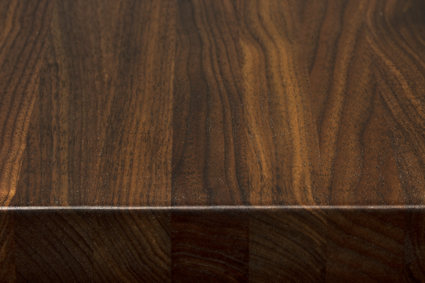 Premium walnut edge grain surface with blended heartwood tones and subtle natural variation