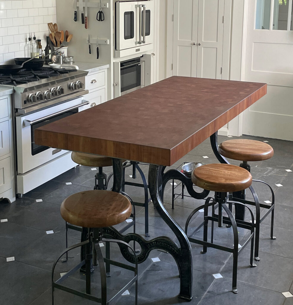 American Black Cherry end grain island table with cast iron base in residential kitchen