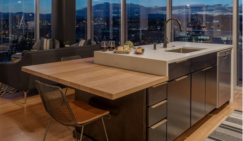 Custom-finished cherry face-grain wood island countertop with matching surround in a modern kitchen