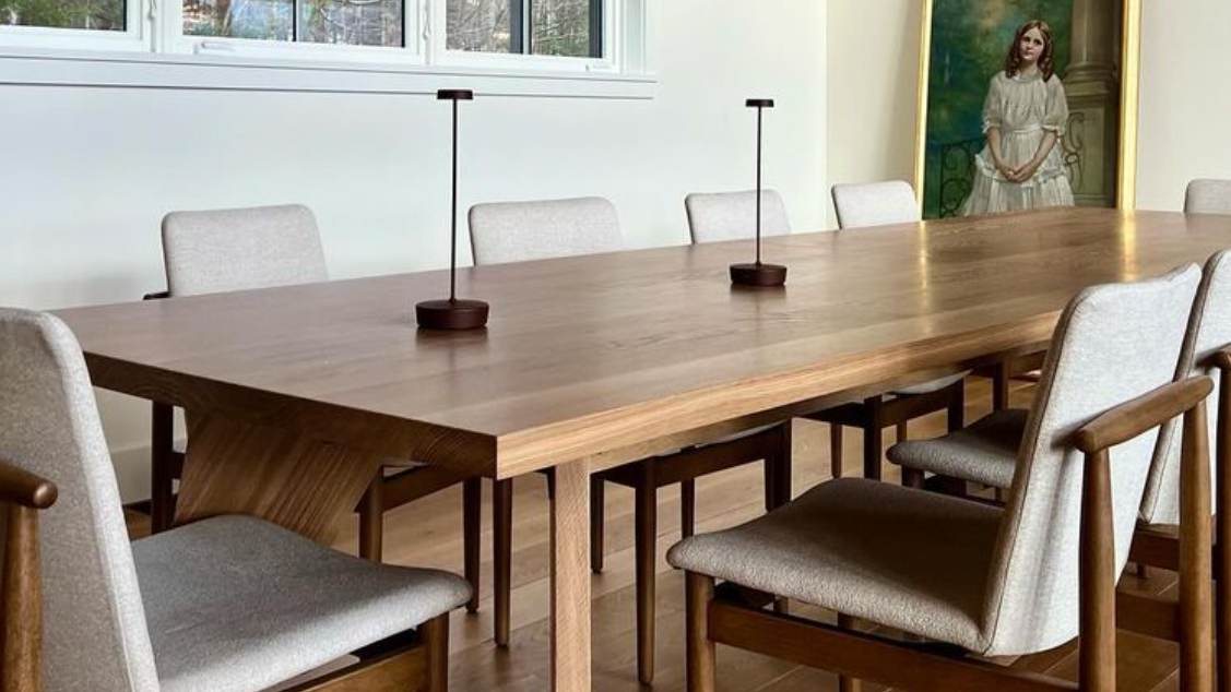 Long white oak dining table with custom wood base and integrated lighting