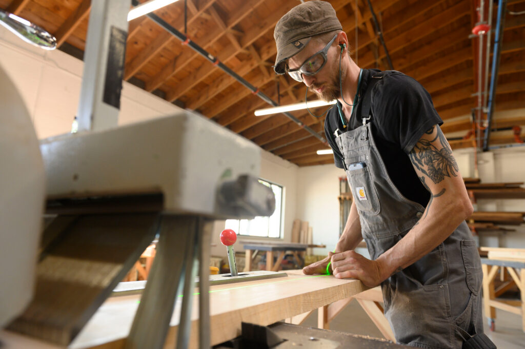 Woodworker milling a solid hardwood surface in the fabrication shop