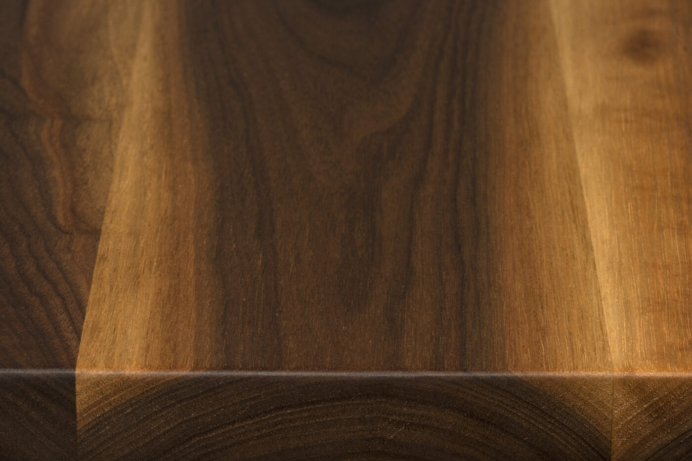Rustic walnut face grain surface showing heartwood and sapwood variation with broader natural grain movement