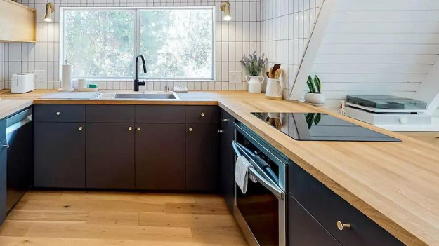 Modern kitchen with white oak countertops and continuous wood work surfaces