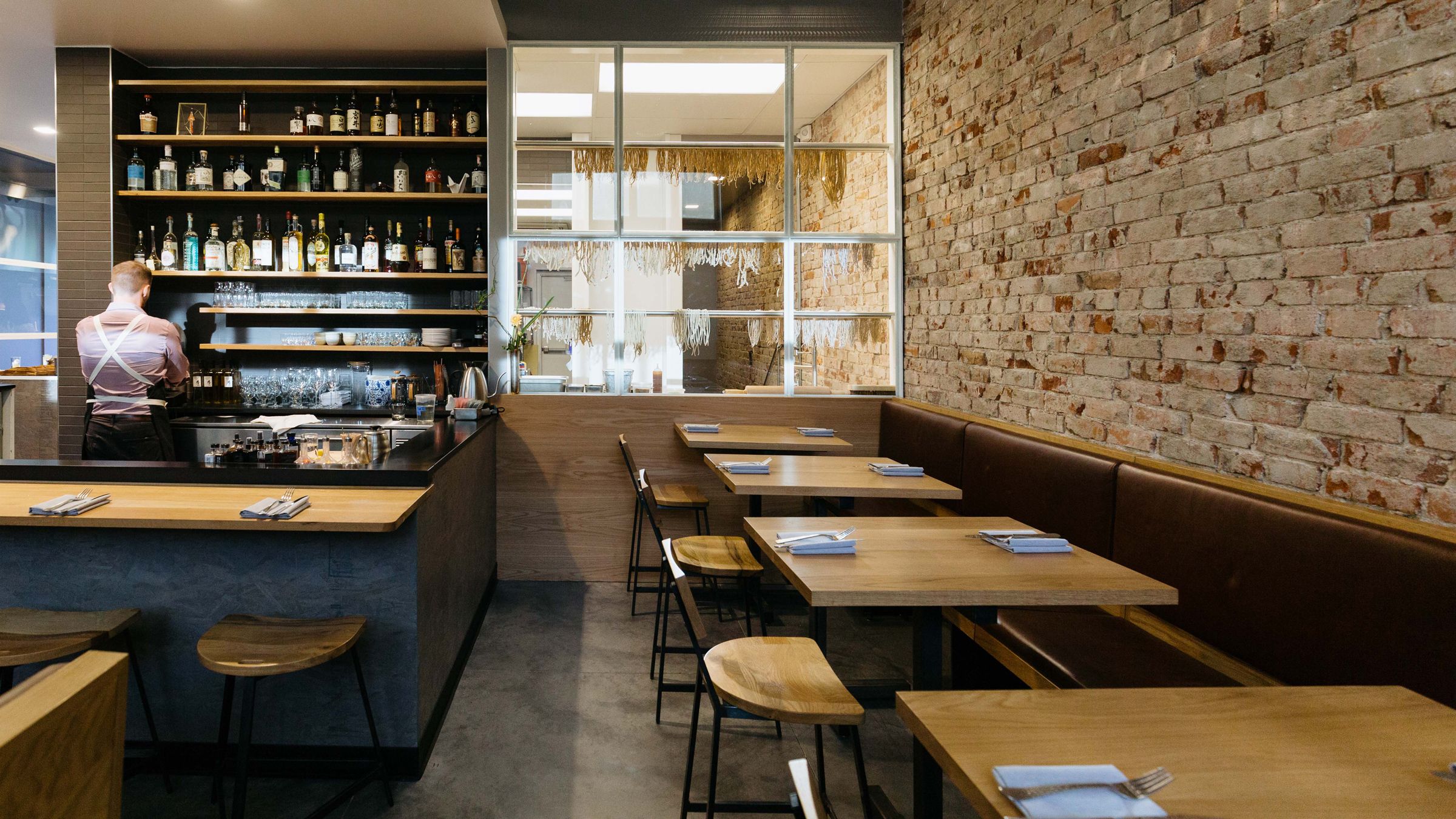 Custom white oak restaurant tables and hospitality surfaces at Wolf’s Tailor Denver