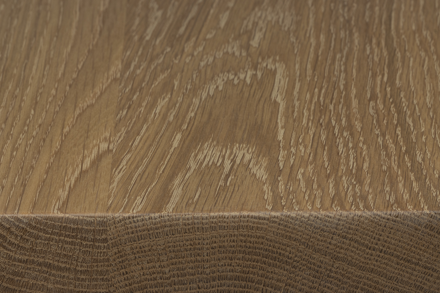 Close-up of a white oak surface showing grain texture and edge detail