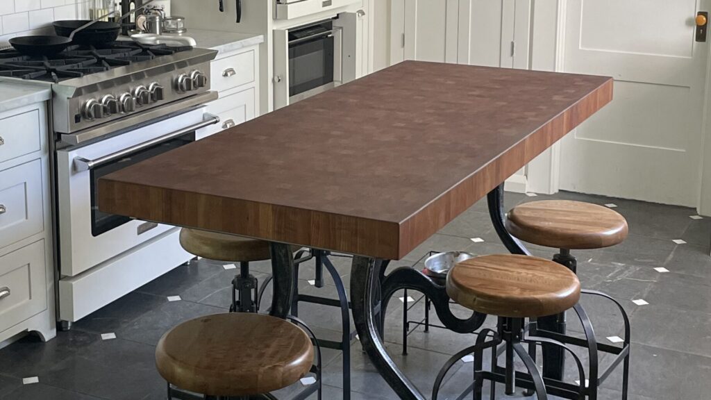American Black Cherry end grain island table with cast iron base in residential kitchen